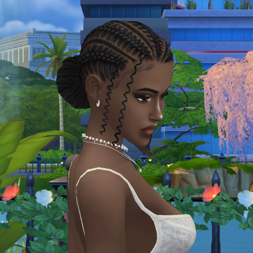 A female Sim wearing Sims 4 CC braided hair poses in a park. She has cornrows leading into a large bun up-do hairstyle, with curly face framing pieces on the side.