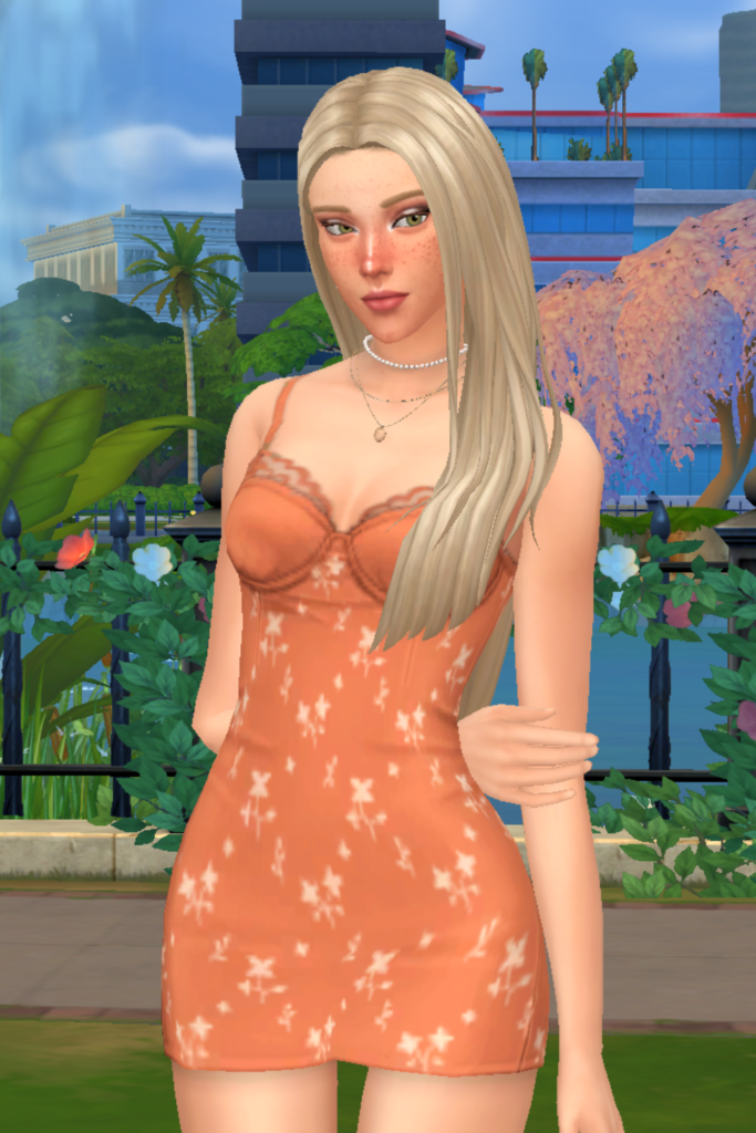 My Favourite Sims 4 CC Mini Dress Finds A blonde female Sim models a Sims 4 CC orange mini dress, consisting of small white flowers