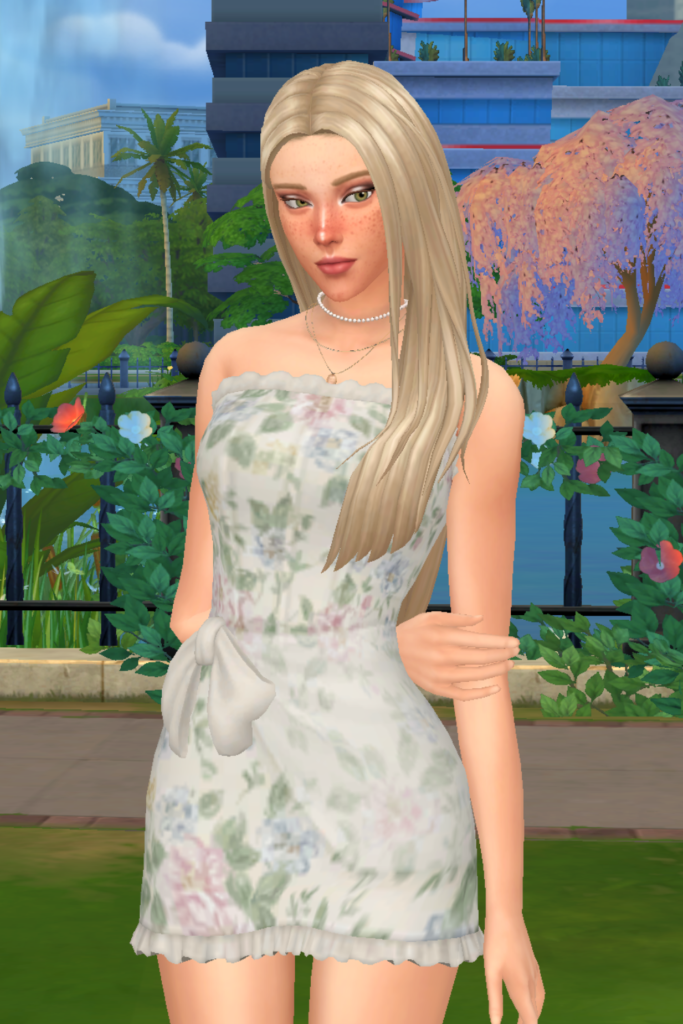 My Favourite Sims 4 CC Mini Dress Finds A blonde female Sim models a Sims 4 CC floral corset mini dress, consisting of a sheer fabric draped along the skirt, ruffles at the hem, and boning details on the top.
