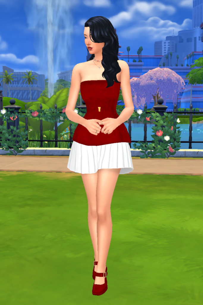 A female Sim wearing a Sims 4 CC outfit stands in a park. She is dressed in a red and white elegant dress. The dress is fit-and-flare style and the skirt has a layered design so the white peaks out. She has on a pair of red mary jane heels.