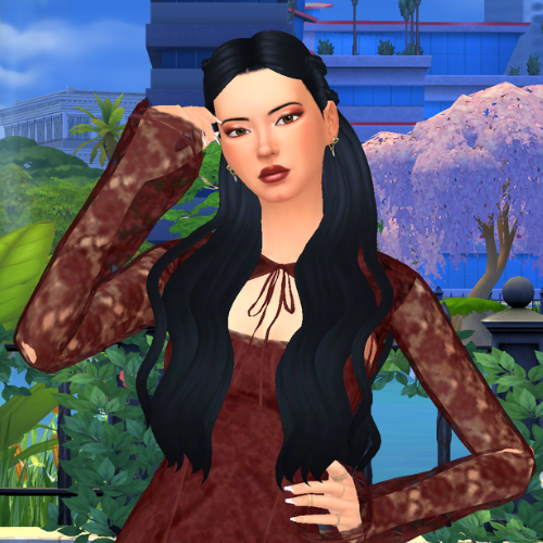 A female Sim wearing Sims 4 CC wavy long hair poses in a park. She has super long half-up half-down hairstyle