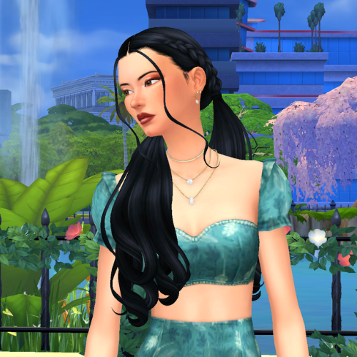 A female Sim wearing Sims 4 CC wavy long hair poses in a park. She has two low pigtails with braids leading into each of the ponytails. The hair is wavy and she has two face framing pieces